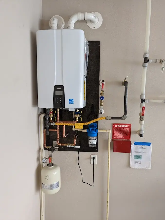 Professional plumber installing copper piping in a Hudson home